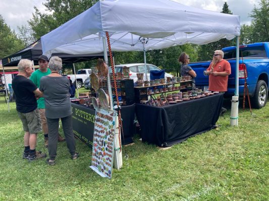 pottery booth and customers at the mines and pines festival in Hibbing, MN